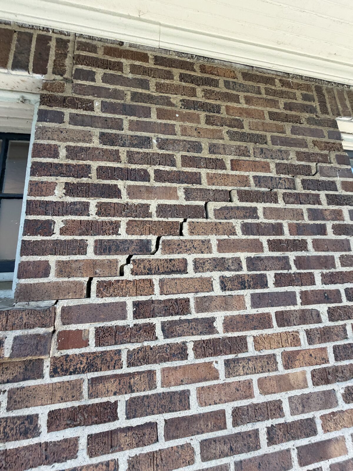 Step crack in brick masonry, a foundation-movement indicator, found during a Dallas-Fort Worth home inspection