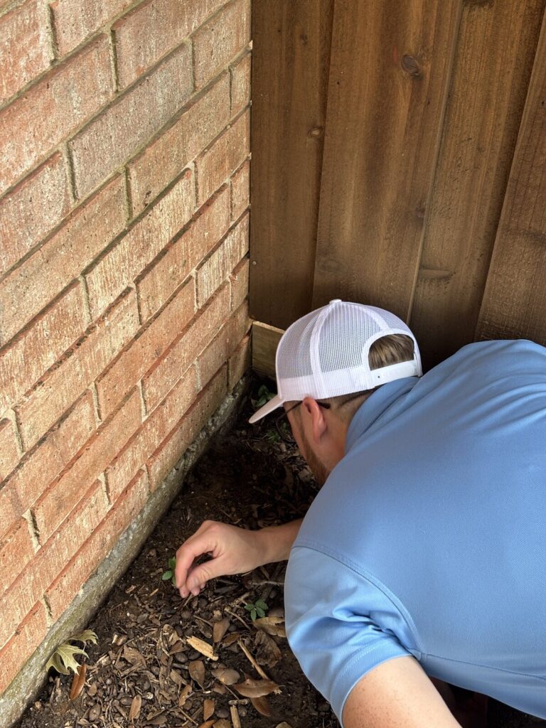 Home inspector examining the foundation perimeter and grading of a Dallas-Fort Worth home - Buffalo Property Inspections
