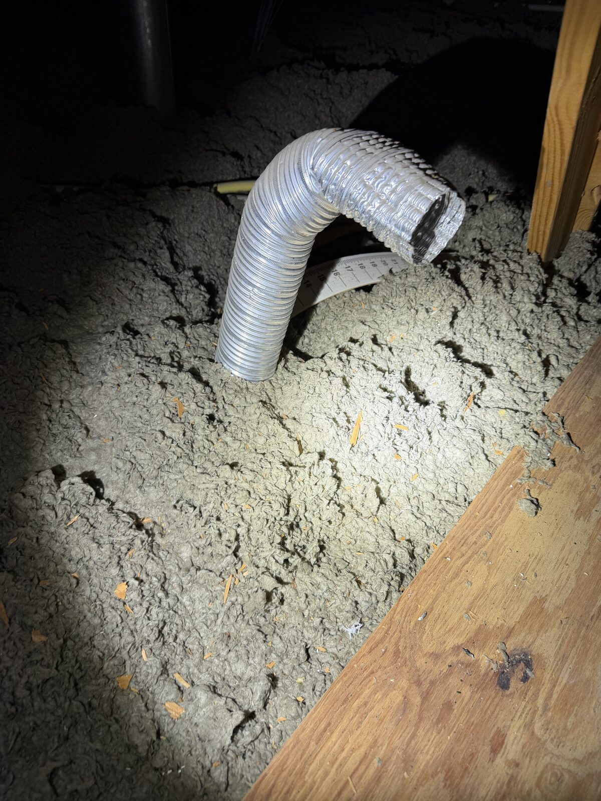 Exhaust vent improperly terminating inside the attic found during a Dallas-Fort Worth home inspection