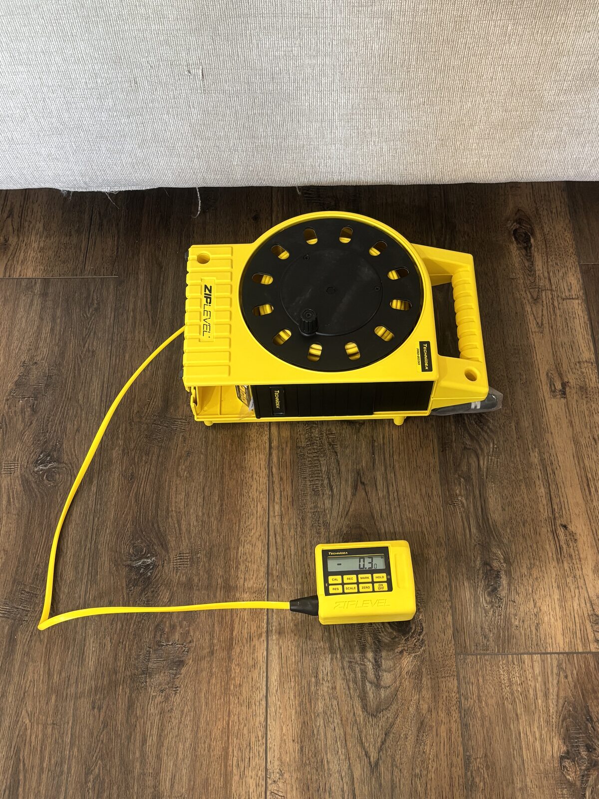 Zip level device measuring floor elevation differences in a Dallas-Fort Worth home