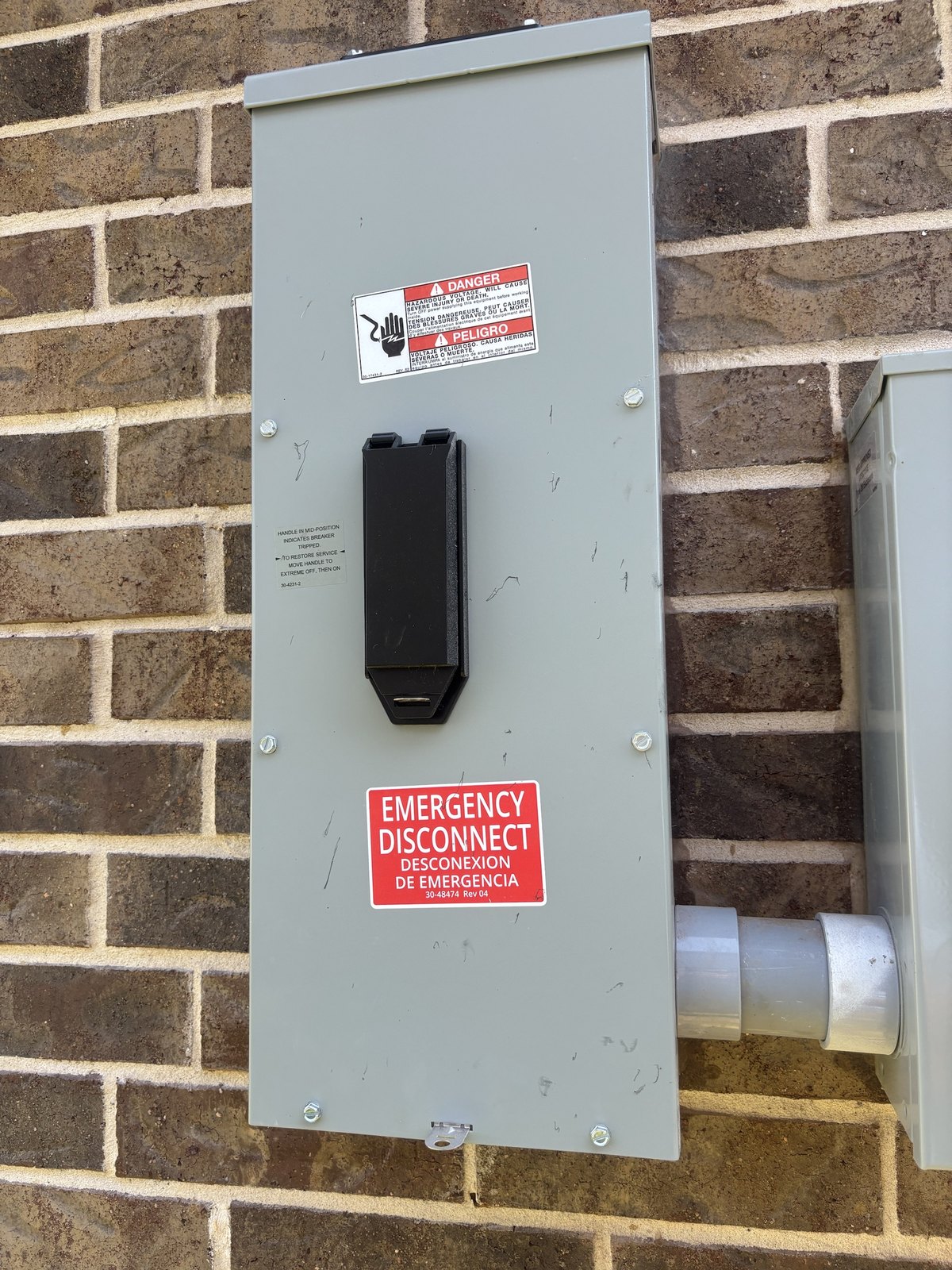 An exterior electrical emergency disconnect being examined in Cedar Hill, Texas during a home inspection by Buffalo Property Inspections