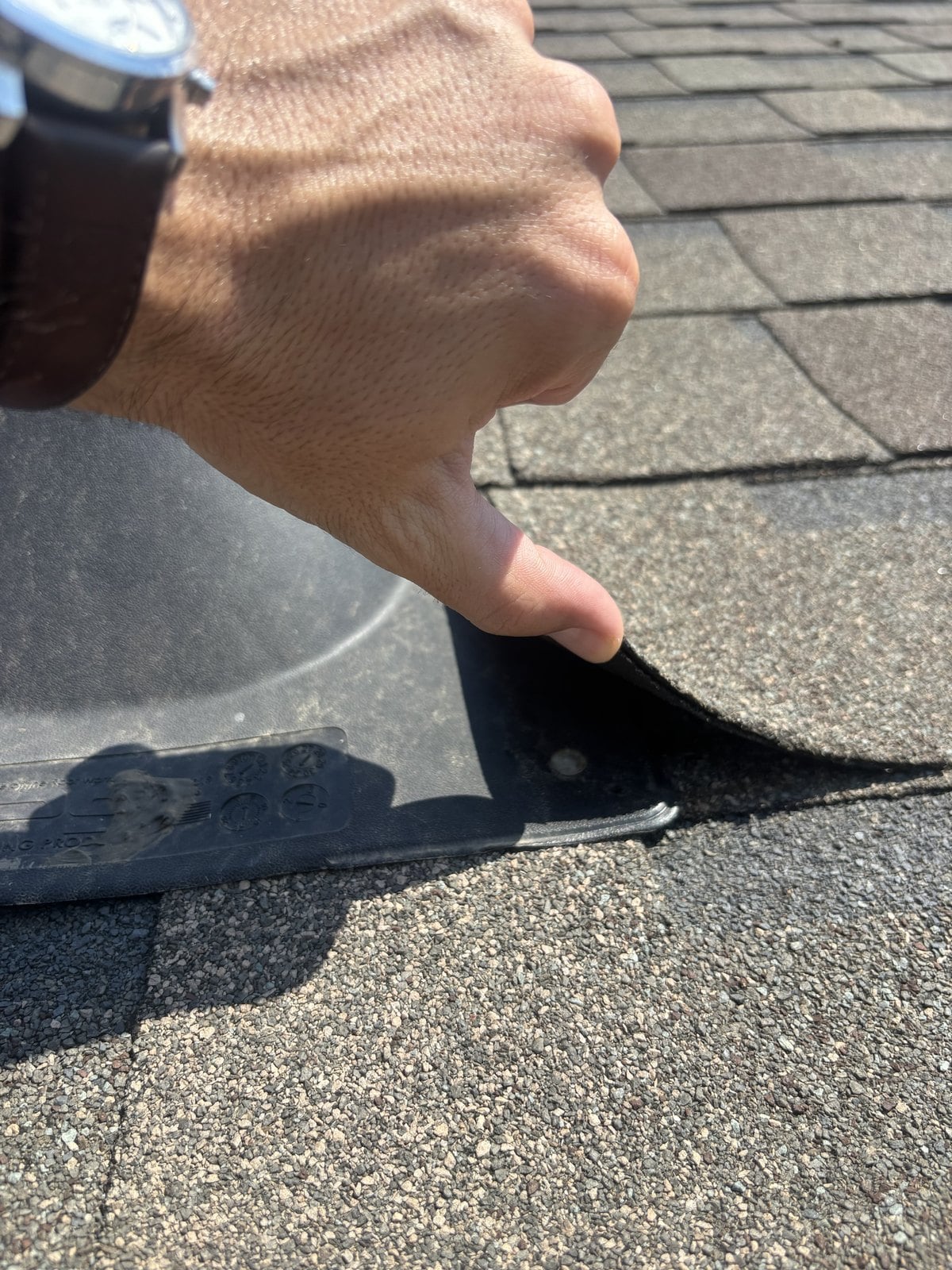 A roof pipe boot and shingle being examined in Coppell, Texas during a home inspection by Buffalo Property Inspections