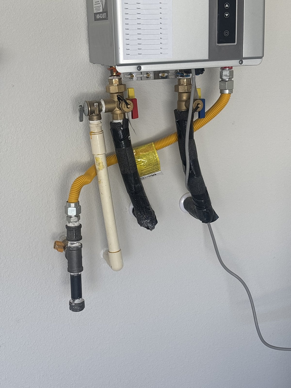 Home Inspector in Keller, TX 1 Tankless water heater connections being examined in Keller, Texas during a home inspection by Buffalo Property Inspections