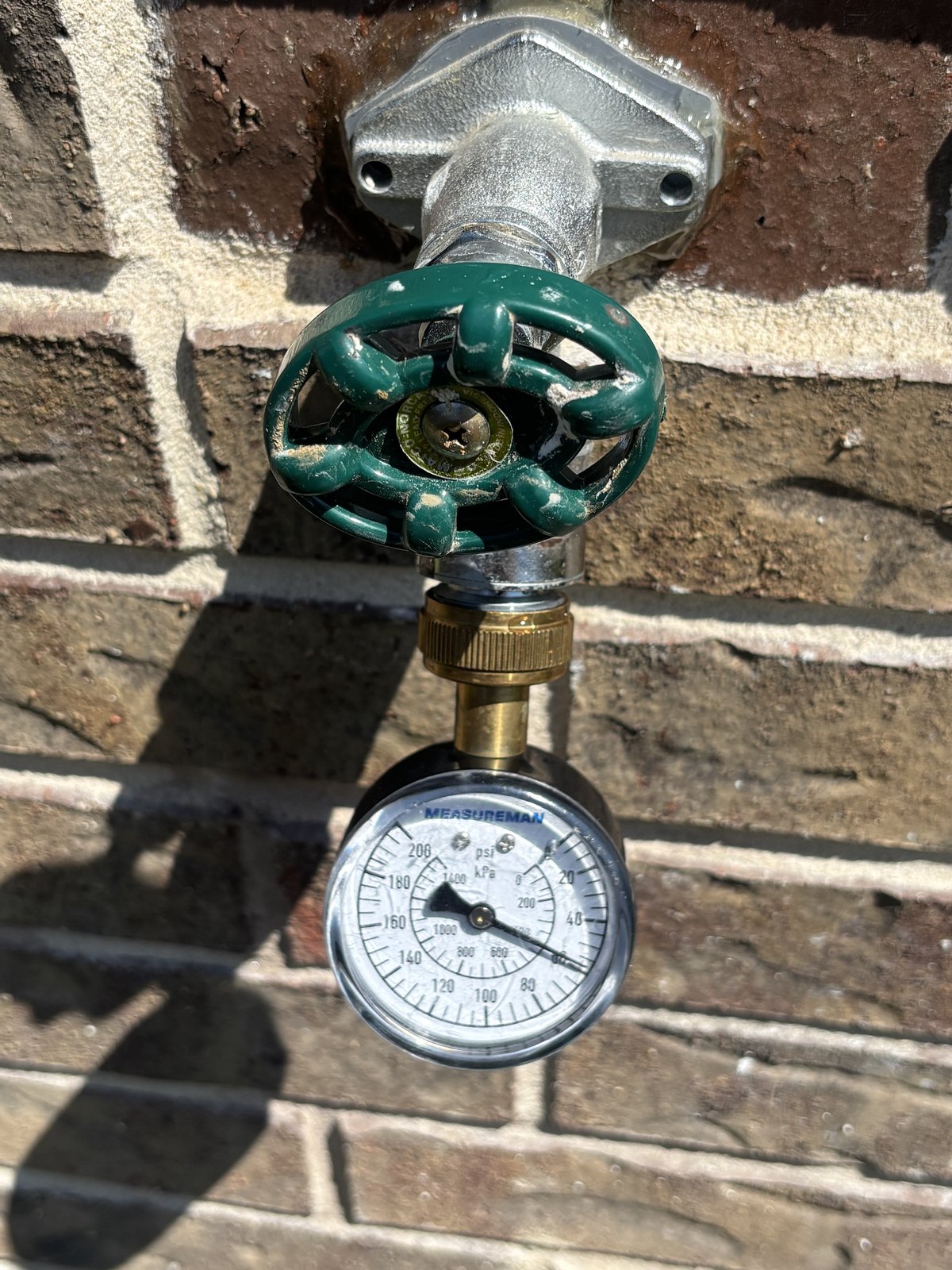 A water pressure gauge on an exterior hose bib in Plano, Texas during a home inspection by Buffalo Property Inspections