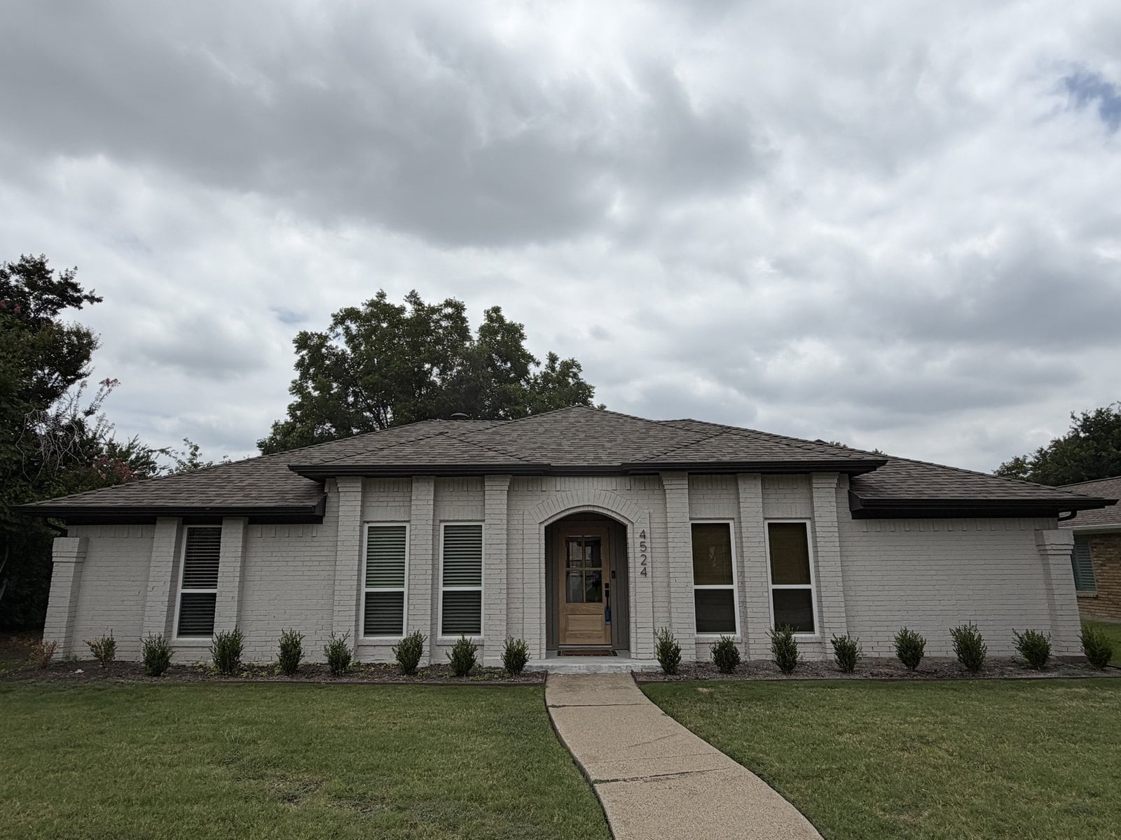A painted white brick ranch home in Grand Prairie, Texas during a home inspection by Buffalo Property Inspections